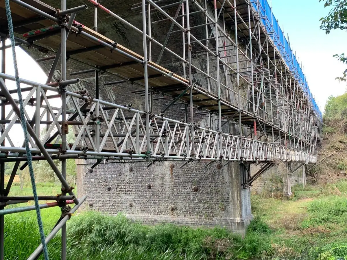The finished structure: beam and bracket support under a viaduct access scaffold