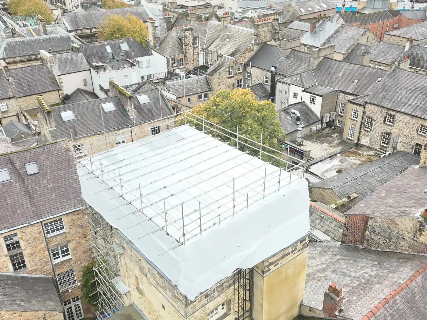 Drone view of the temporary roof over the Music Room, Lancaster, among the rooftops