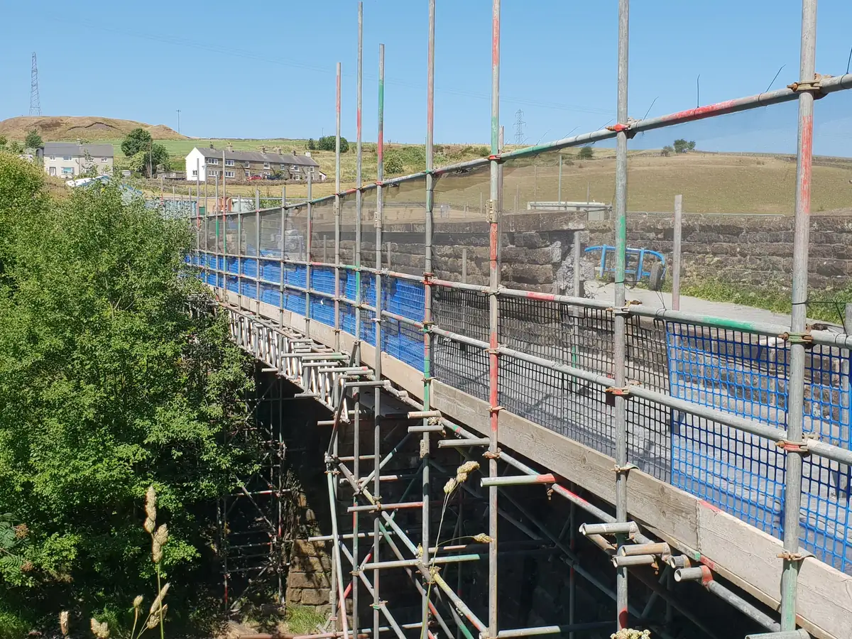 Parapet access scaffold on a rail overbridge in open country