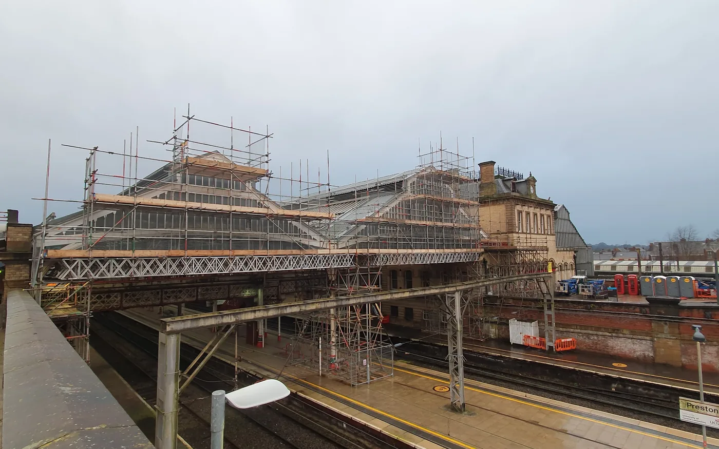Scaffold over a station canopy beside live platforms